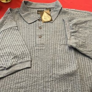 Men’s short sleeve polo blue w/knit band at the bottom. New. Stain blocker. Nice